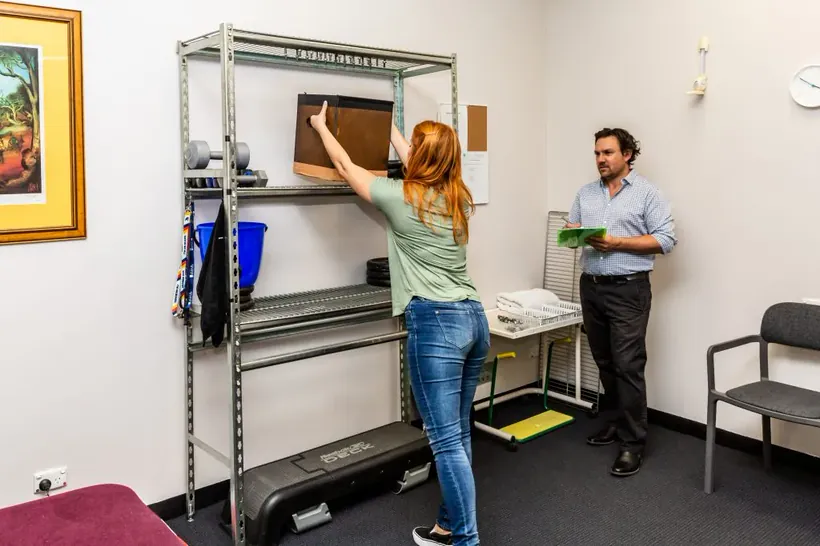 Occupational therapist guiding a patient through a functional reaching task