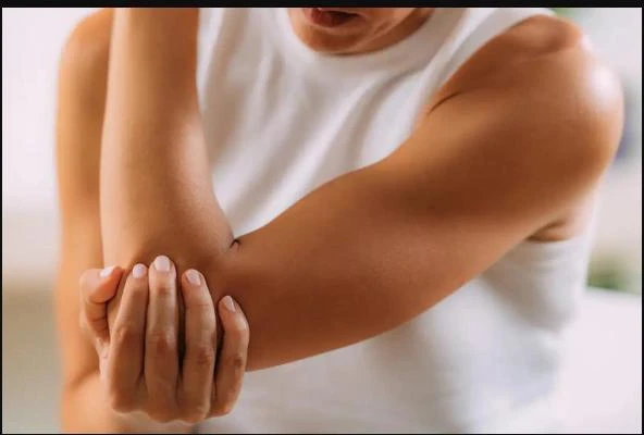 Person holding their own elbow in discomfort
