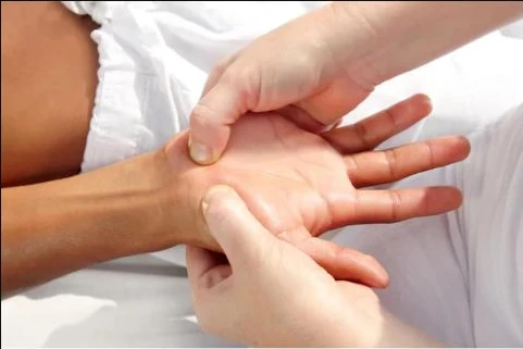 Certified hand therapist guiding a patient through a one-on-one hand session